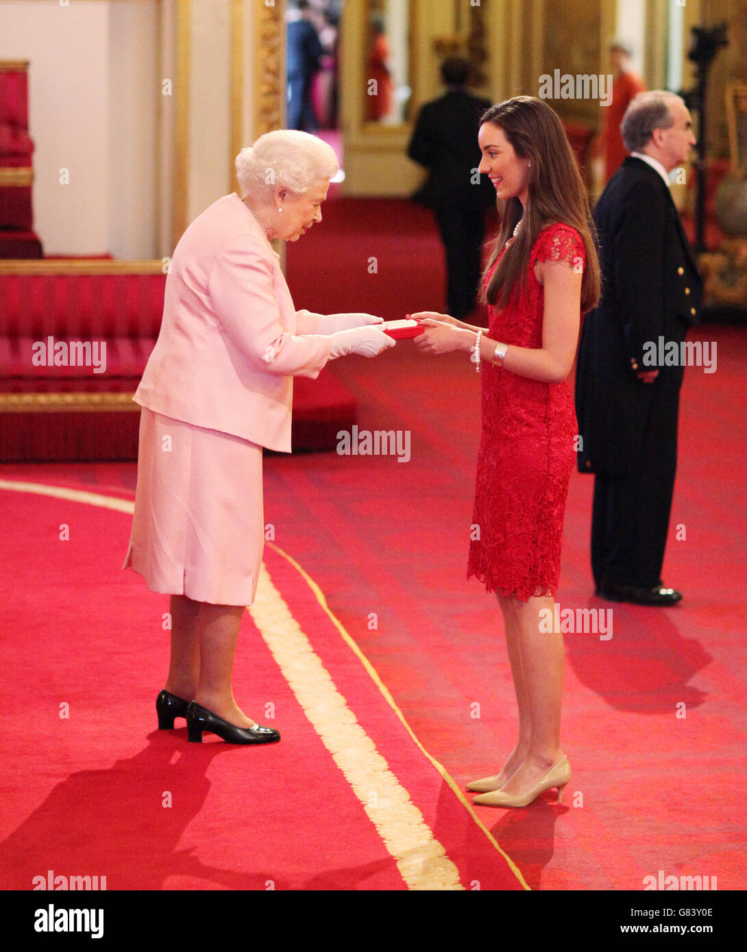Kate Row from Australia meets Queen Elizabeth II at Buckingham Palace, London during the ceremony for the 2015 winners of The Queen's Young Leaders Awards. Stock Photo
