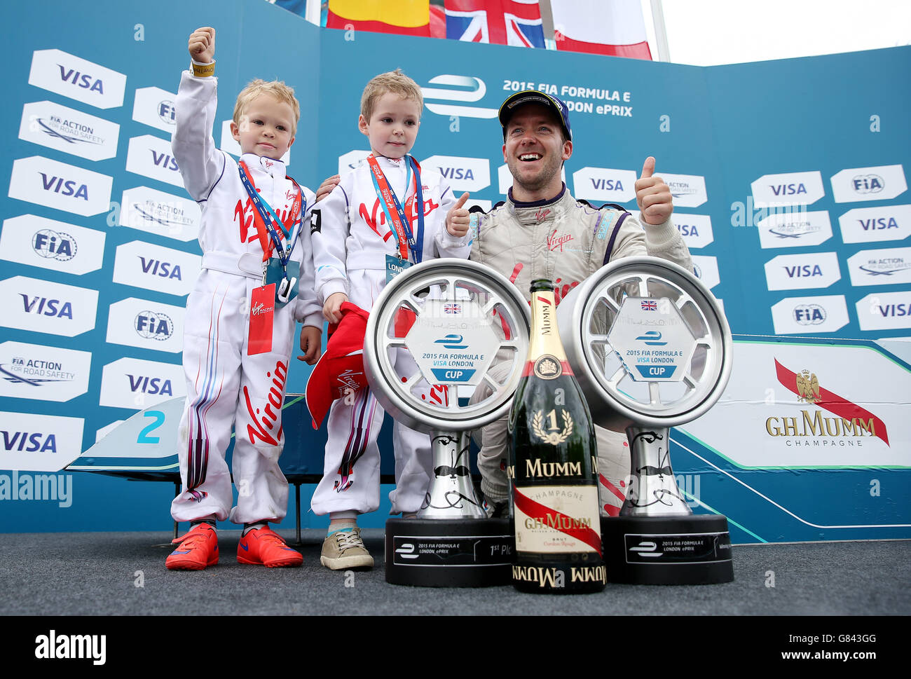 Sam Bird celebrates his victory with his sons Flynn and Zak after the Visa London ePrix at Battersea Park, London. Stock Photo