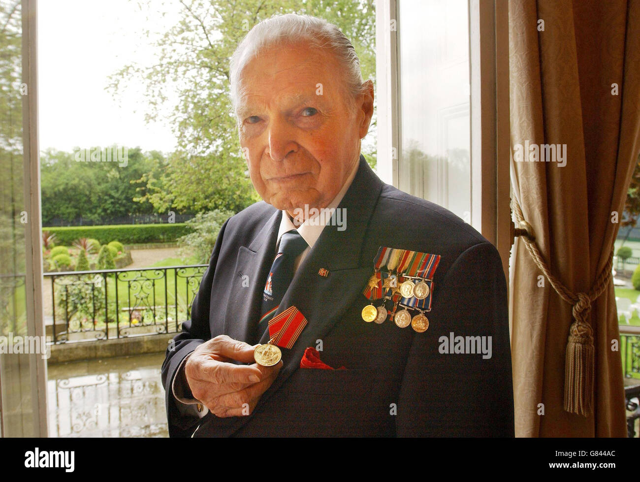 Commander Eddie Grenfell, a survivor of the Artic Convoys of 1941-45 at the Russian Embassy in London where he received a commemorative medal from the Russian Ambassador, Gregory Karasin, marking the 60th anniversary of the end of what Russians term the 'Great Patriotic War'. Stock Photo