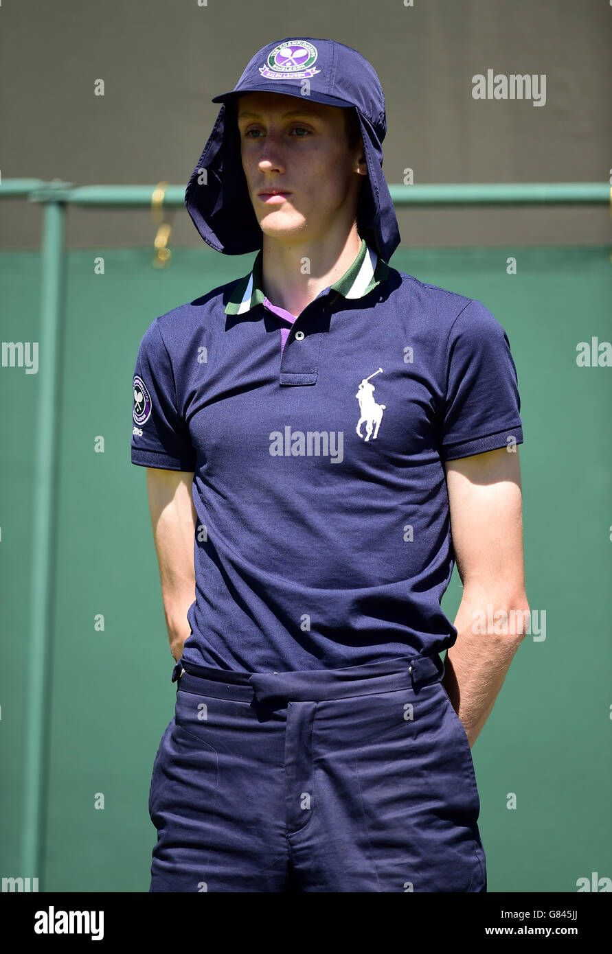 A boy wearing a larger cap to protect from the sun during day two of the Wimbledon Championships at the All England Lawn Tennis and Croquet Club, Wimbledon Stock Photo -