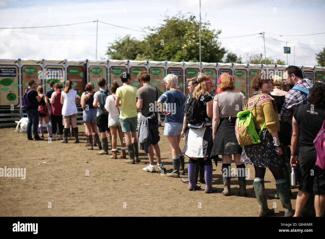 Festival goers queuing toilets glastonbury festival hi-res stock