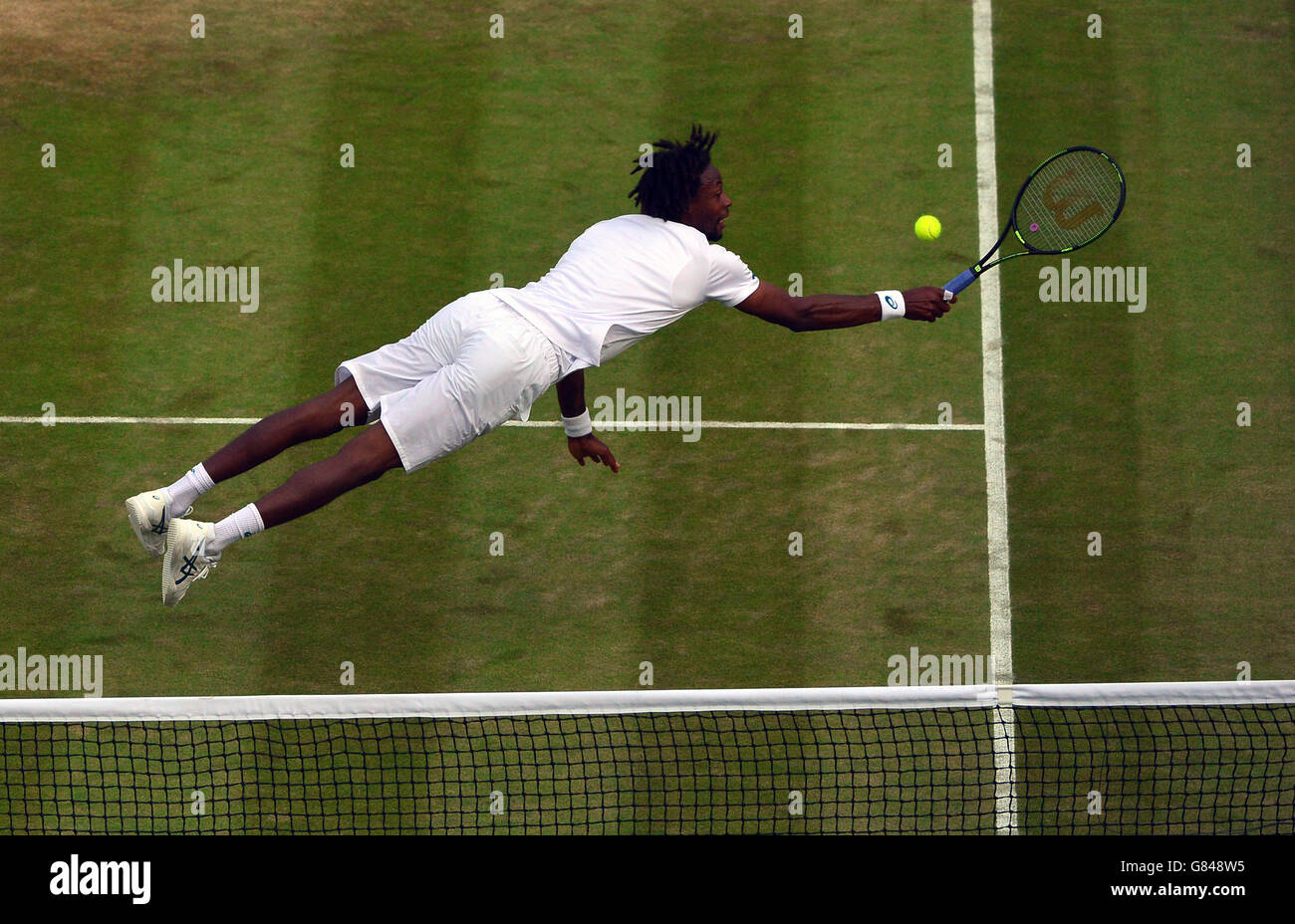 Gael Monfils in action against Gilles Simon during day Six of the Wimbledon Championships at the All England Lawn Tennis and Croquet Club, Wimbledon. Stock Photo
