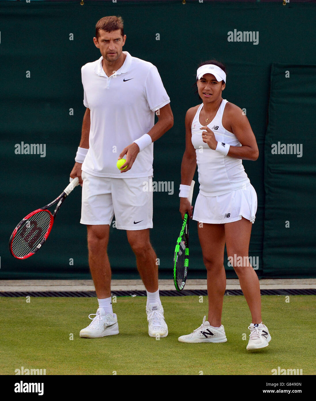 Heather Watson and Max Mirnyi in their doubles match during day Six of the Wimbledon Championships at the All England Lawn Tennis and Croquet Club, Wimbledon. Stock Photo