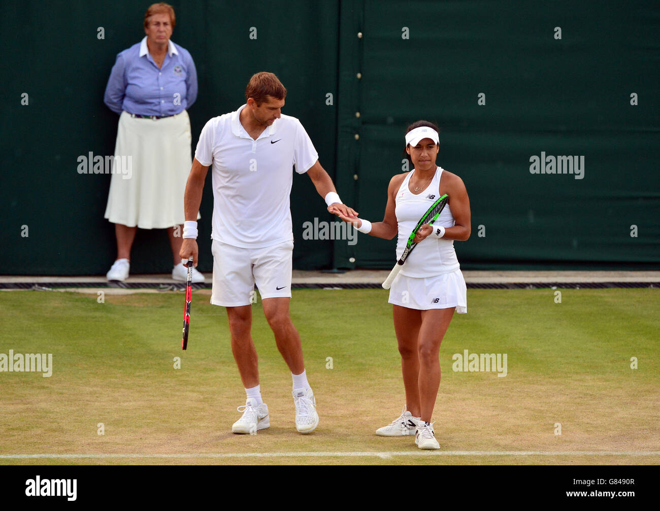 Heather Watson and Max Mirnyi in their doubles match during day Six of the Wimbledon Championships at the All England Lawn Tennis and Croquet Club, Wimbledon. Stock Photo