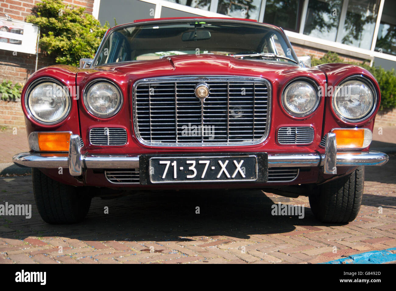 MEDEMBLIK, THE NETHERLANDS - JULY 27,2014 : Front view of a red Jaguar XJ 6 4,2 on a oldtimer show Stock Photo