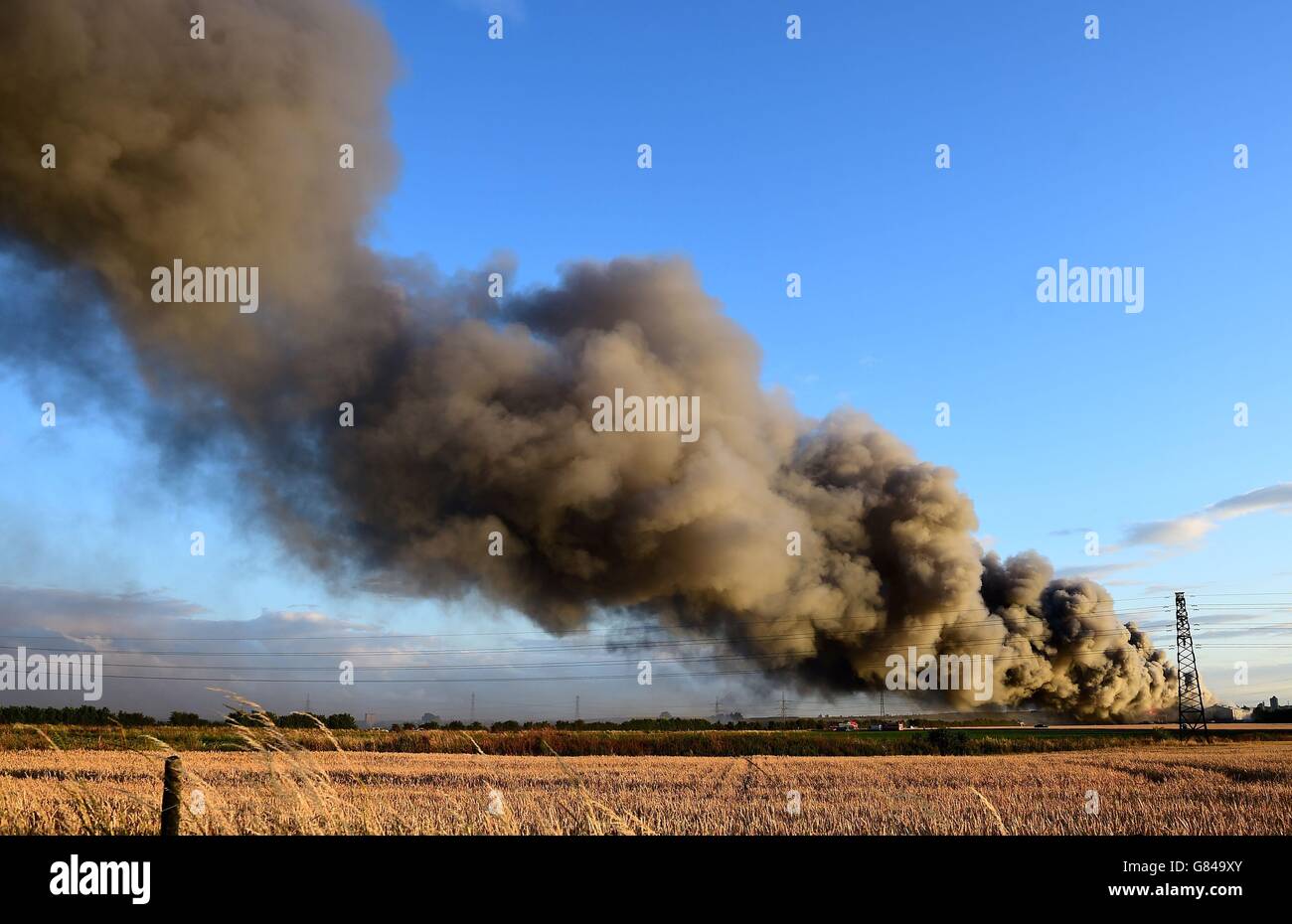 Firefighters and officers tackle a fire at a pallet yard on East Hall