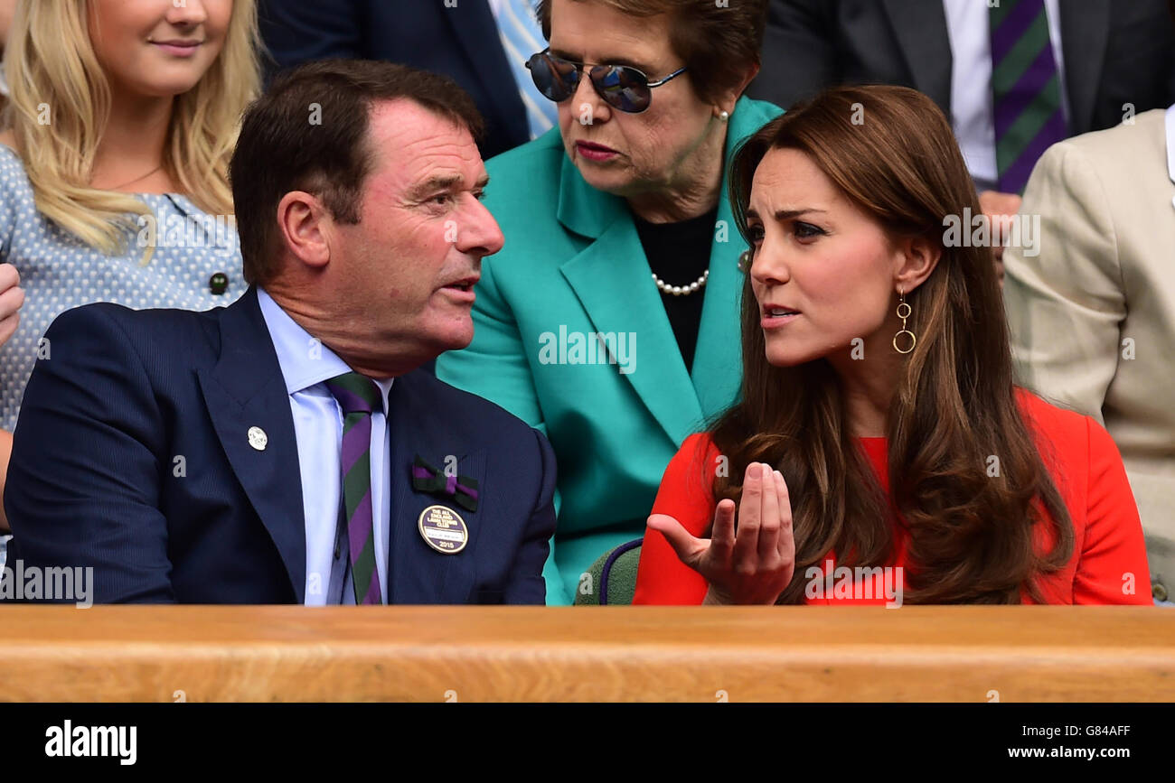 The Duchess of Cambridge chats with Chairman of the AELTC Philip Brook (left) in the Royal Box on day Nine of the Wimbledon Championships at the All England Lawn Tennis and Croquet Club, Wimbledon. Stock Photo