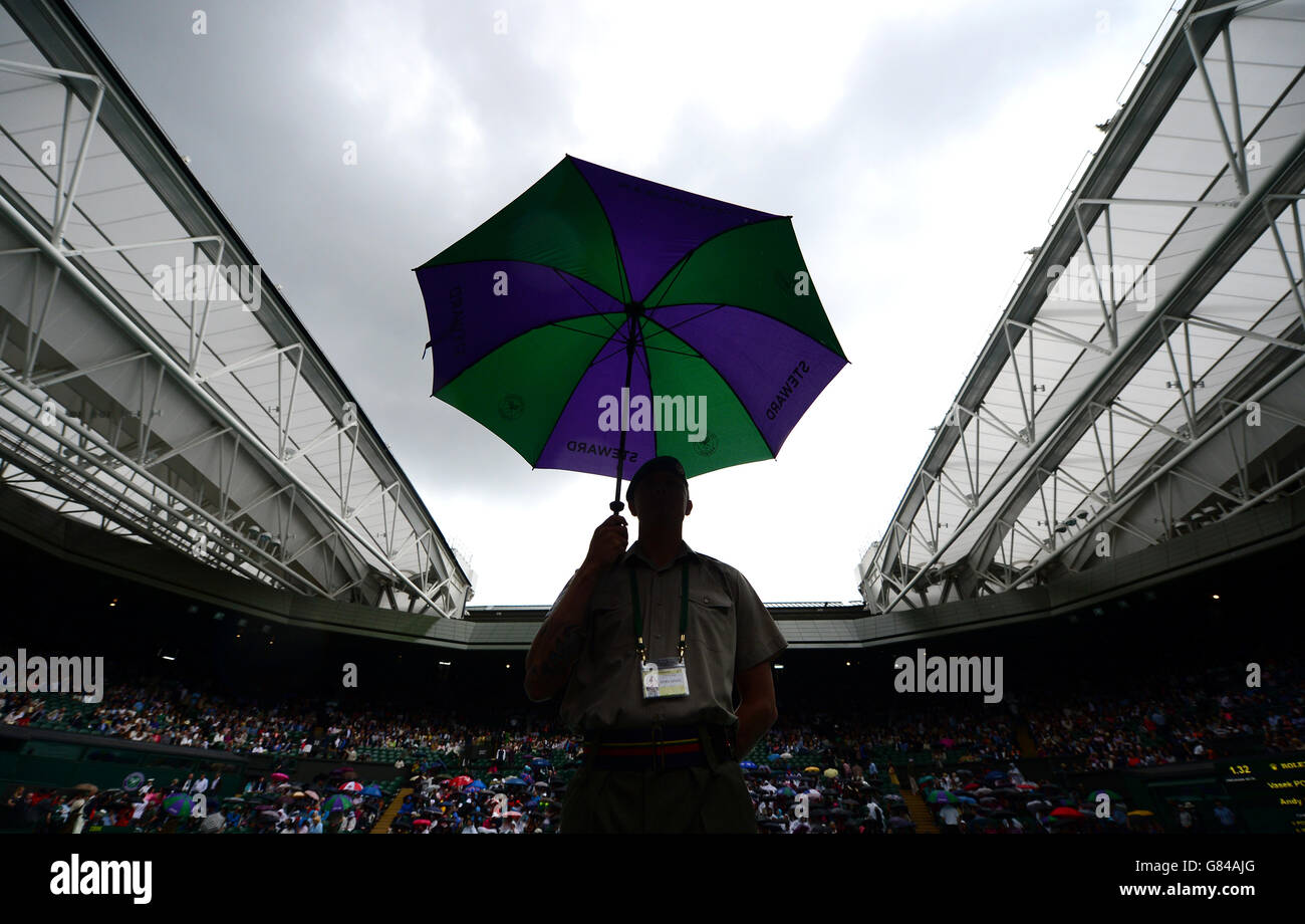 Rain stops play on centre court during day Nine of the Wimbledon Championships at the All England Lawn Tennis and Croquet Club, Wimbledon. Stock Photo