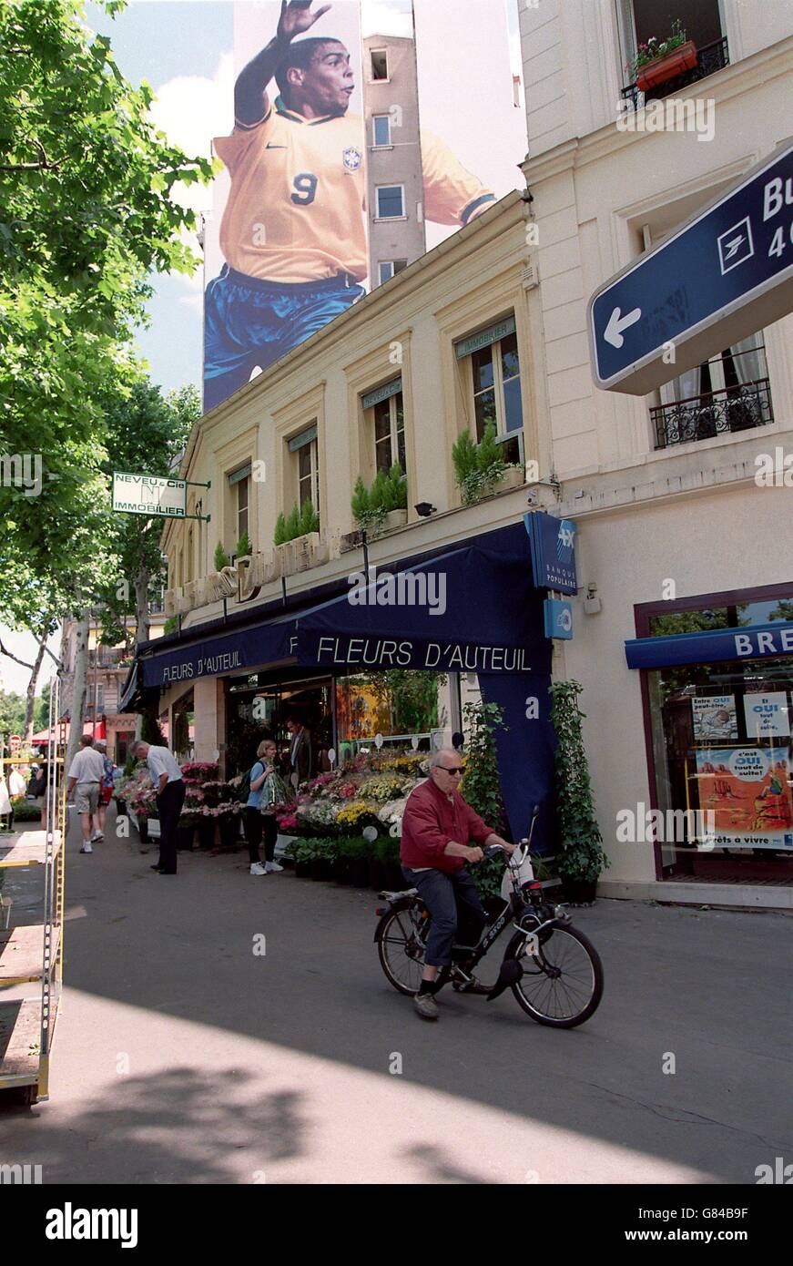Ronaldo the Brazilian footballer looks down onr a Paris street near the Parc Des Princes from a Nike billboard Stock Photo