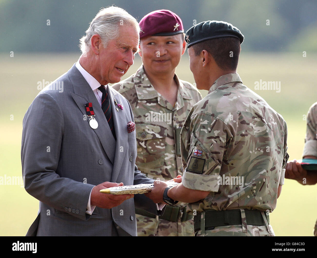 The Prince of Wales, Colonel in Chief of The Royal Gurkha Rifles, examines a traditional kukri knife during a visit to 2nd Battalion The Royal Gurkha Rifles at Shorncliffe barracks in Folkestone, Kent, to celebrate 200 years of Gurkha service to the Crown on July 1. Stock Photo