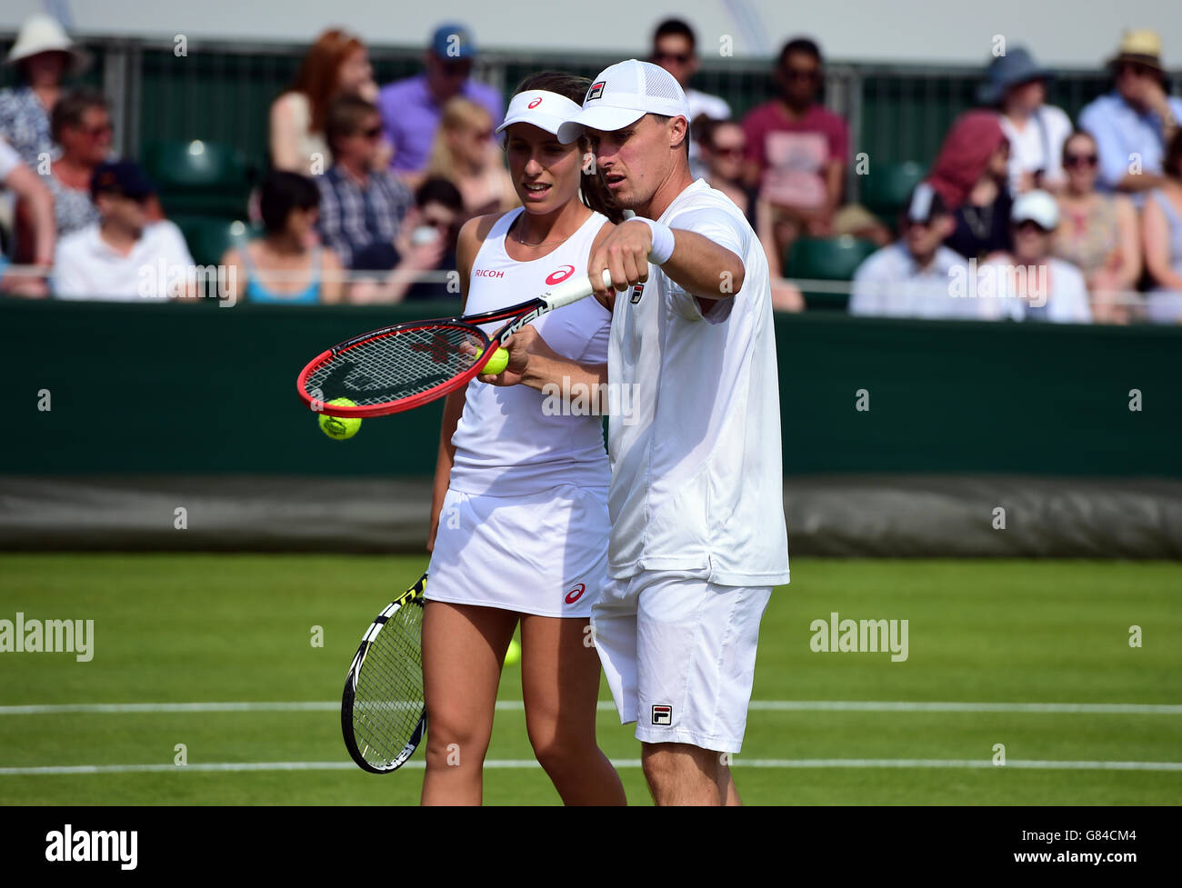 Johanna Konta and Ken Skupski during their doubles match on day Five of the Wimbledon Championships at the All England Lawn Tennis and Croquet Club, Wimbledon. Stock Photo