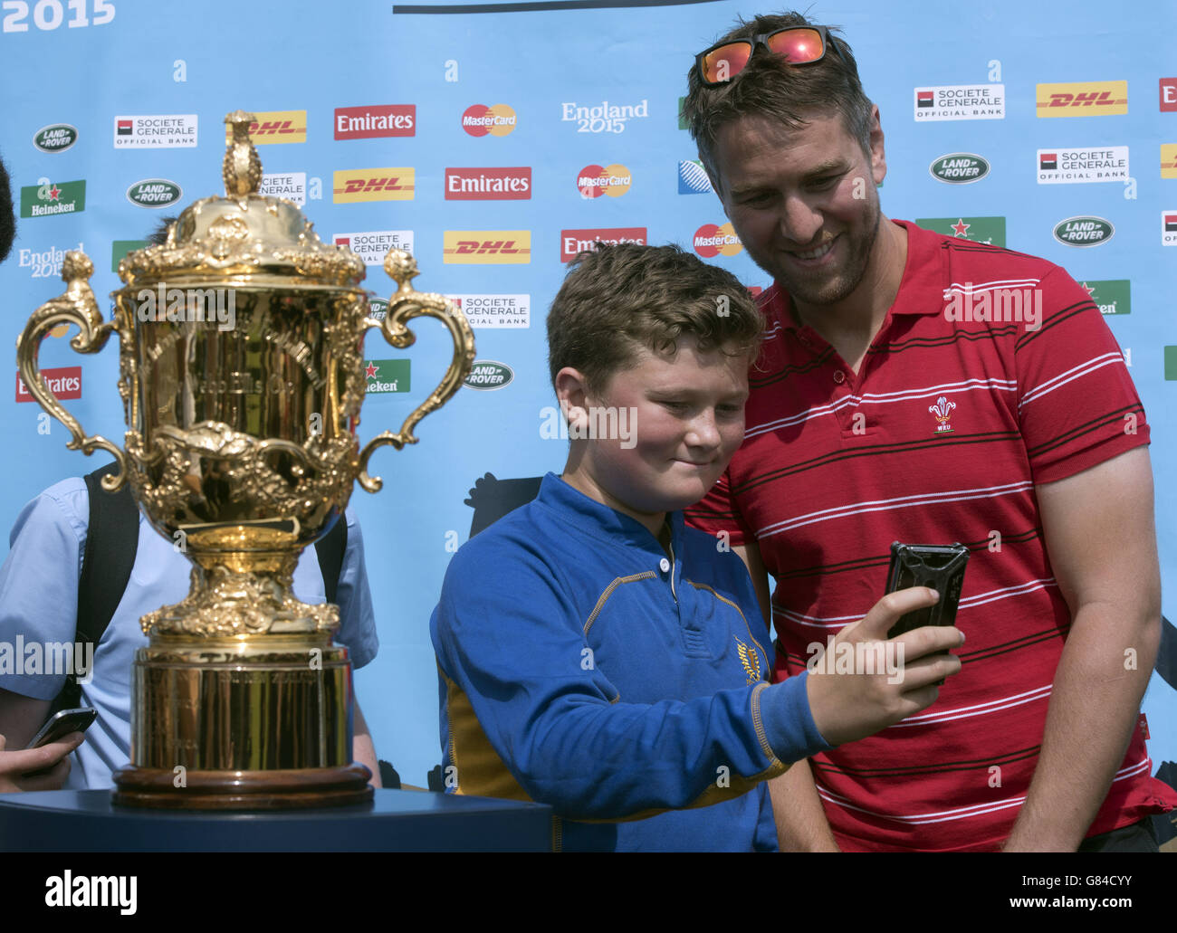 Evan Smith takes a selfie with Former Welsh International Rugby player Ryan Jones with the Webb Ellis Cup as it visits Bassaleg High School in Newport as part of the 100 day Rugby World Cup Trophy Tour of the UK & Ireland. Stock Photo
