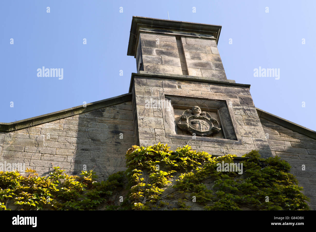 Chimney breast featuring a coat of arms at Matfen Hall in Northumberland, England. Stock Photo