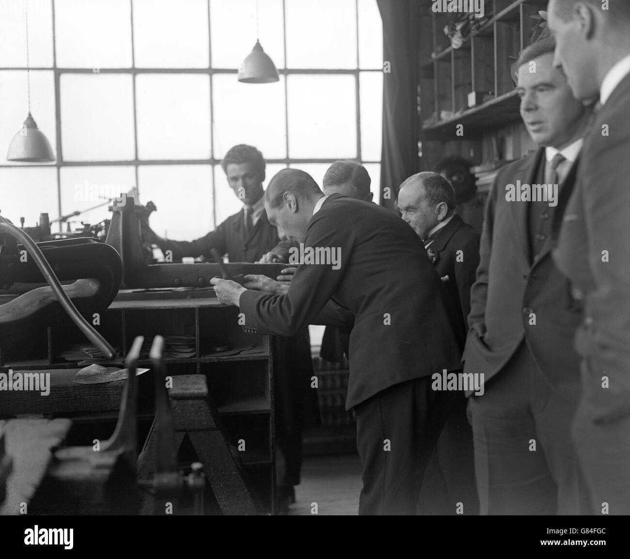The Duke of York examines a fitting machine during a visit to the boot factory of Crockett and Jones in Northampton. Stock Photo