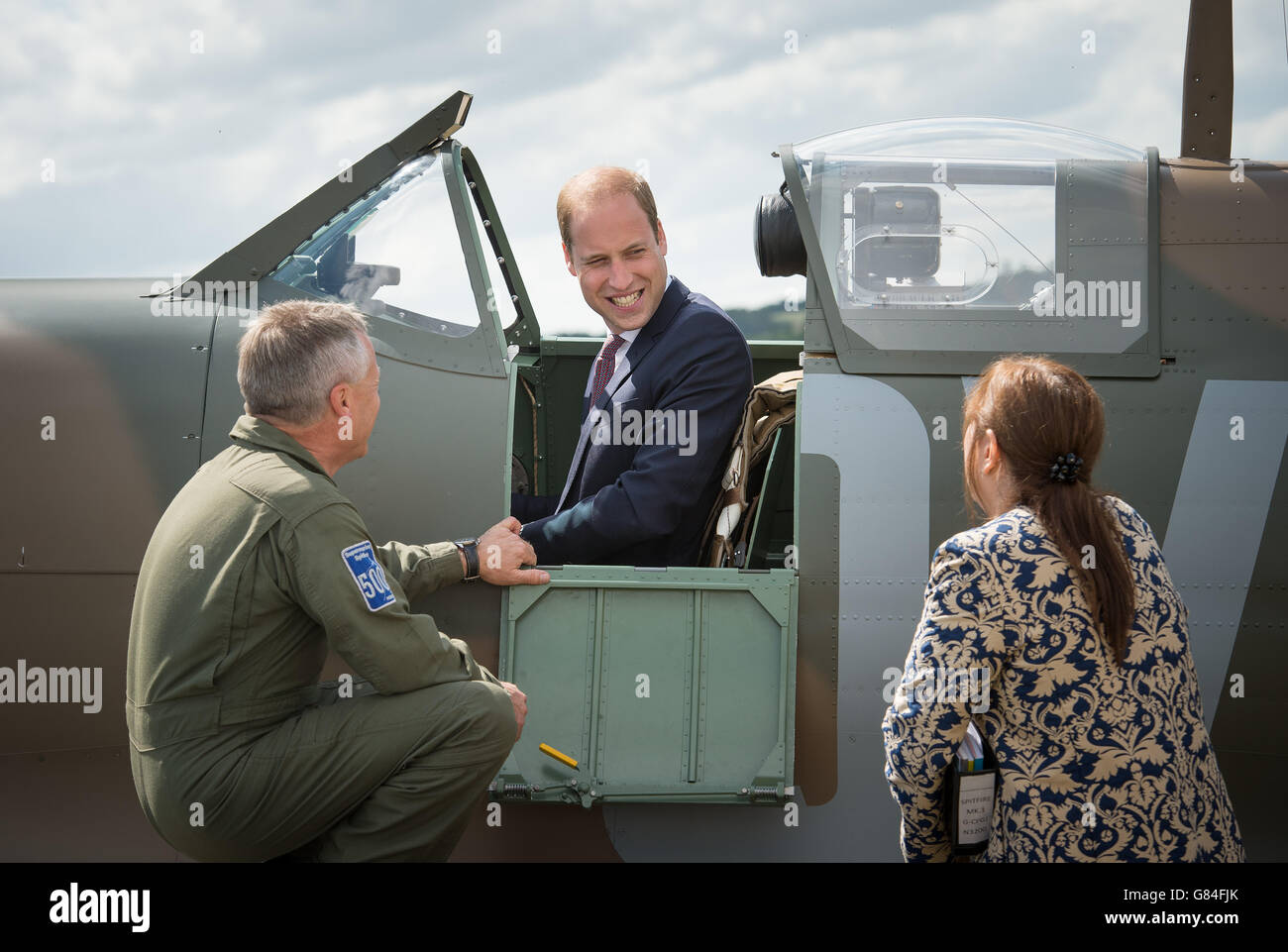 The managing director of the Aircraft Restoration Company (ARC) and pilot John Romain (left) talks to Imperial War Museum director general Diane Lees and the Duke of Cambridge as he sits in a newly restored Supermarine Spitfire Mark I N3200 which was donated to the Imperial War Museum in Duxford by American philanthropist Thomas Kaplan. Stock Photo