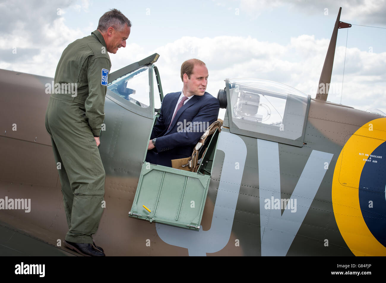 The managing director of the Aircraft Restoration Company (ARC) and pilot John Romain (left) talks to the Duke of Cambridge as he sits in a newly restored Supermarine Spitfire Mark I N3200 which was donated to the Imperial War Museum in Duxford by American philanthropist Thomas Kaplan. Stock Photo