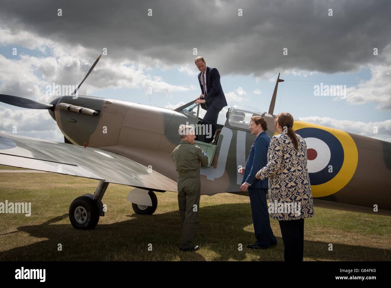 The managing director of the Aircraft Restoration Company (ARC) and pilot John Romain (left) talks to American philanthropist Thomas Kaplan (second right), Imperial War Museum director general Diane Lees and the Duke of Cambridge as he climbs out of a newly restored Supermarine Spitfire Mark I N3200 which was donated to the Imperial War Museum in Duxford. Stock Photo
