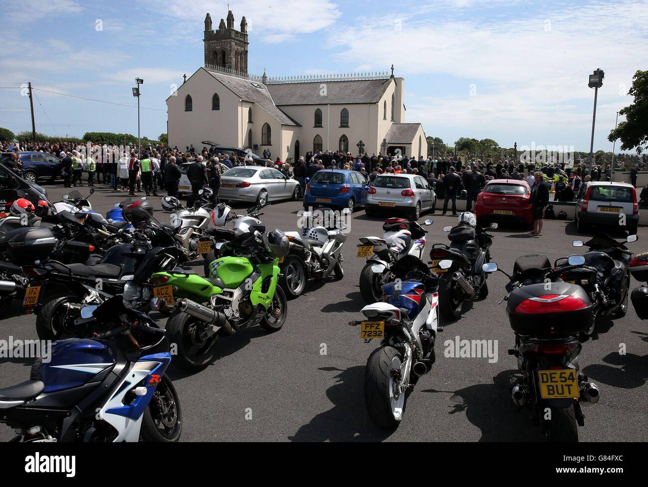 Motorcycles parked outside St Patrick's Church in Portaferry, Co. Down, during the requiem mass of motorbike racing doctor John Hinds. Stock Photo