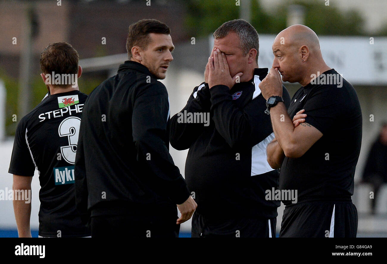 Bala Town manager Colin Caton (second right) looks dejected after the ...