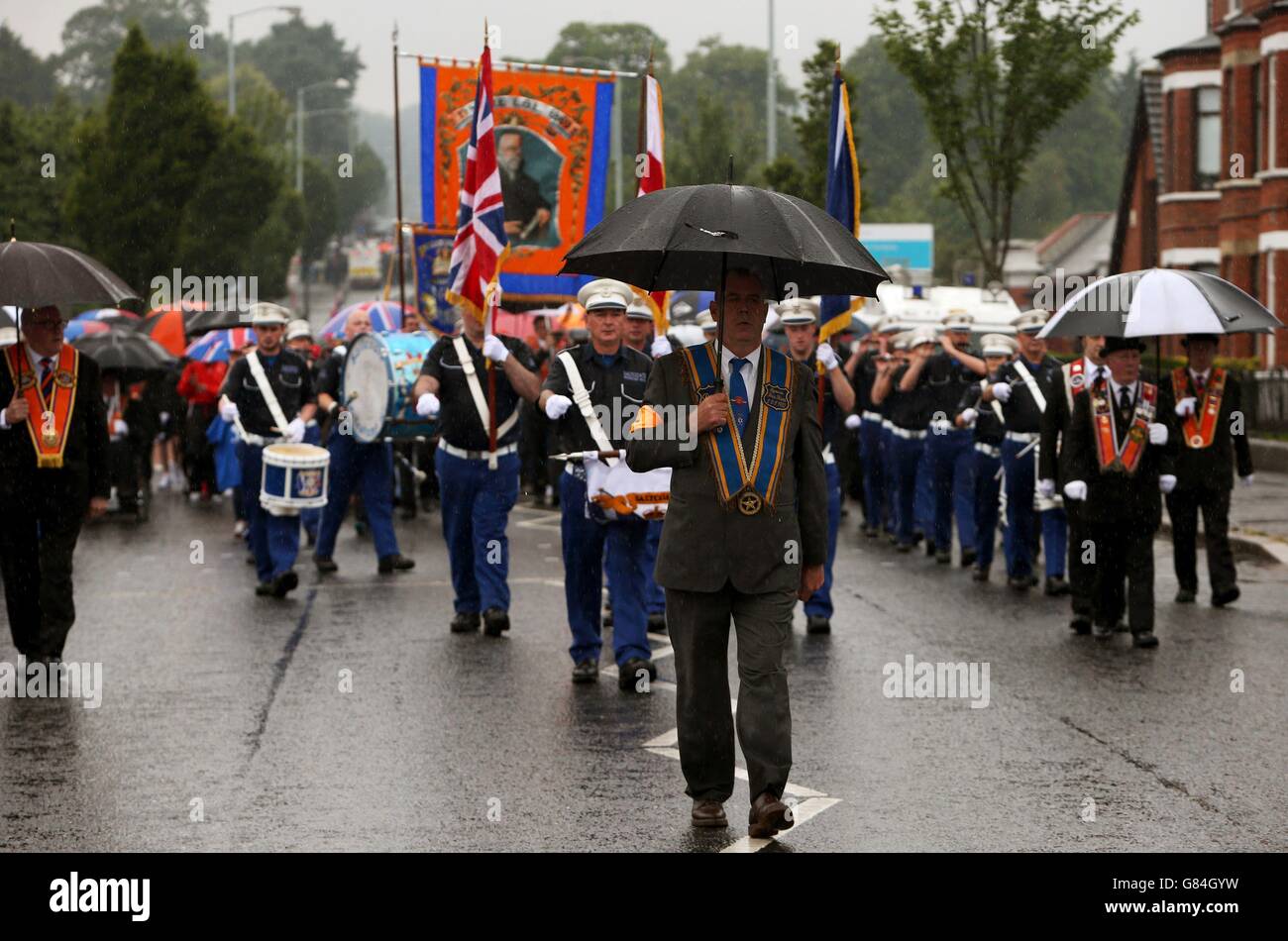 An Orange Order parade on Crumlin Road, Belfast, adjacent to the nationalist Ardoyne neighbourhood as part of the annual Twelfth of July celebrations, marking the victory of King William III's victory over James II at the Battle of the Boyne in 1690. Stock Photo