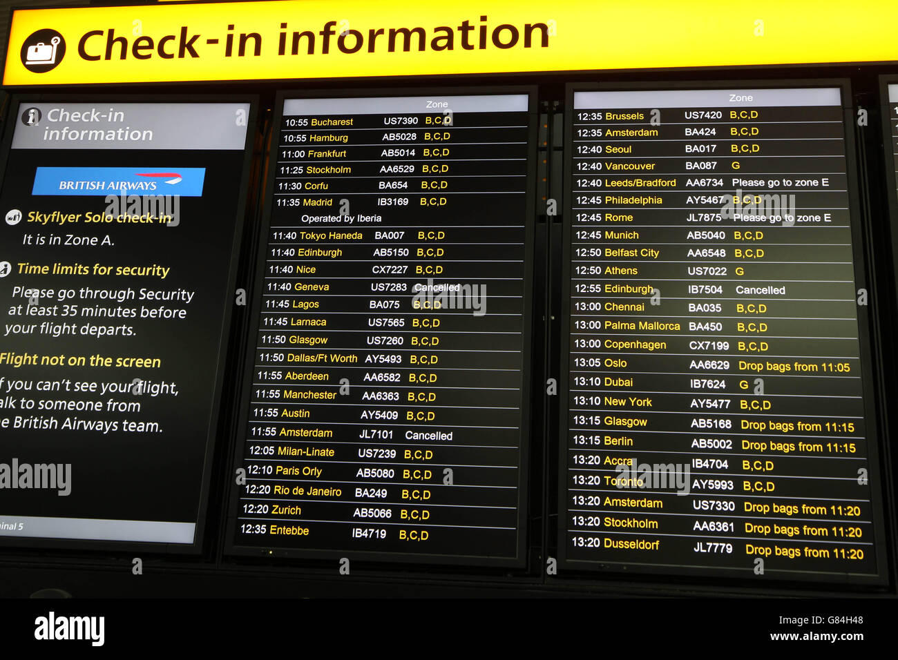 Flight Information boards showing a few cancelled flights in Terminal 5 of Heathrow Airport, as travellers were warned to expect disruption after climate change activists stage a protest on the north runway at Heathrow Airport. Stock Photo