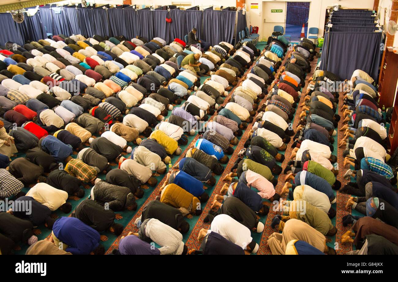 Muslim men take part in evening prayers, during Ramadan at the East London Mosque, in Whitechapel, London. Stock Photo