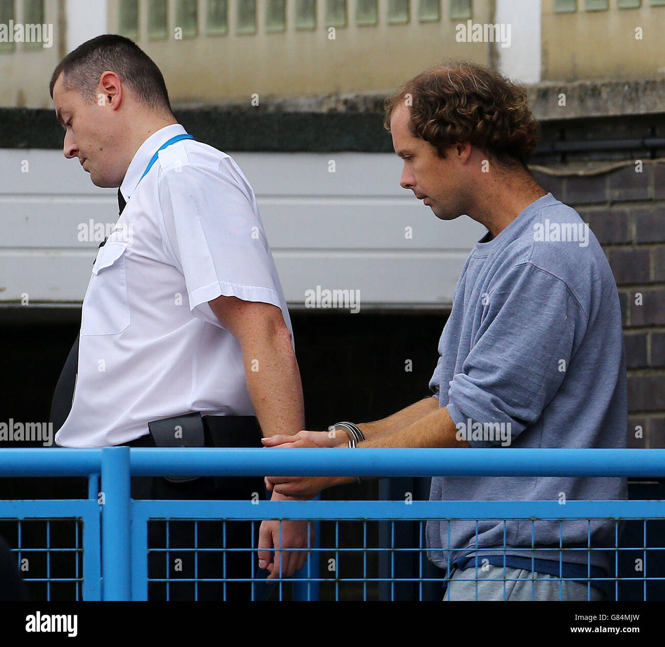 Matthew Daley (right) is led away from Crawley Magistrates Court after being charged with murdering a great-grandfather Donald Lock in a road rage stabbing after a car crash. Stock Photo