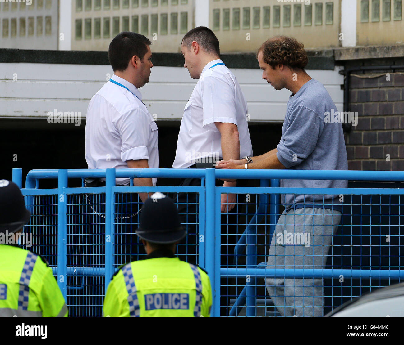 Matthew Daley (right) is led away from Crawley Magistrates Court after being charged with murdering a great-grandfather Donald Lock in a road rage stabbing after a car crash. Stock Photo