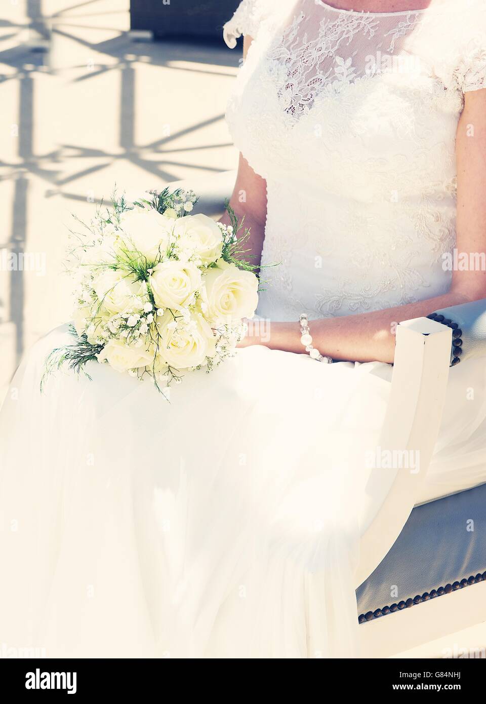 Bride sitting with bridal flower bouquet Stock Photo - Alamy