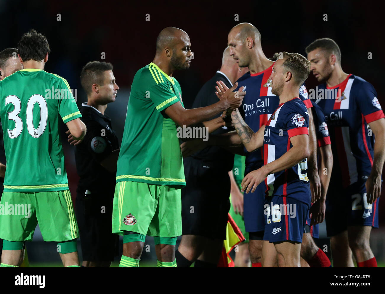 Sunderland's Younes Kaboul shakes hands with Doncaster Rovers' James Coppinger (right) after the final whistle after the Pre-Season Friendly match at the Keepmoat Stadium, Doncaster. Stock Photo