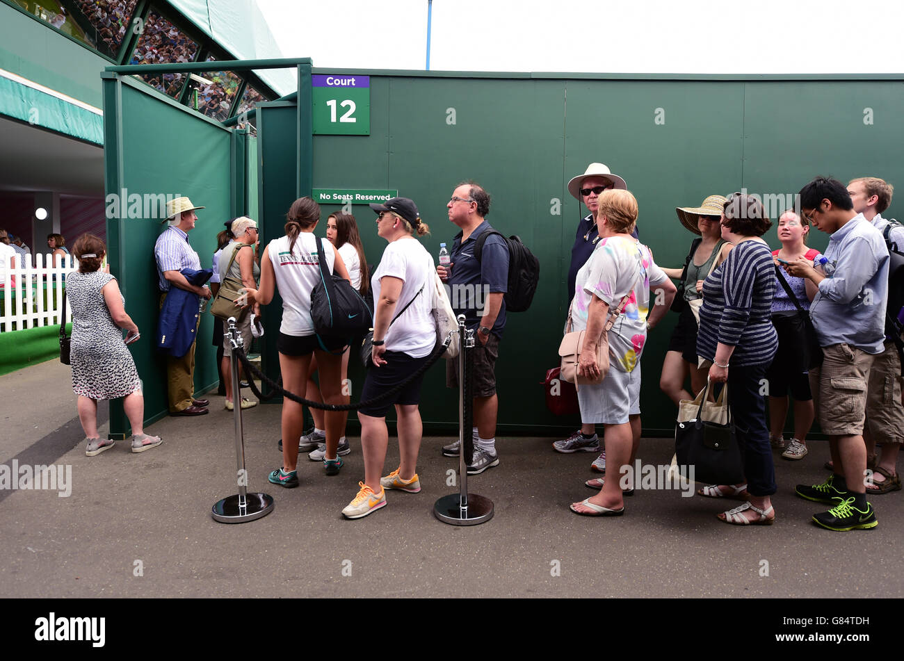 Spectators queue for a seat on court twelve during day Three of the Wimbledon Championships at the All England Lawn Tennis and Croquet Club, Wimbledon. Stock Photo