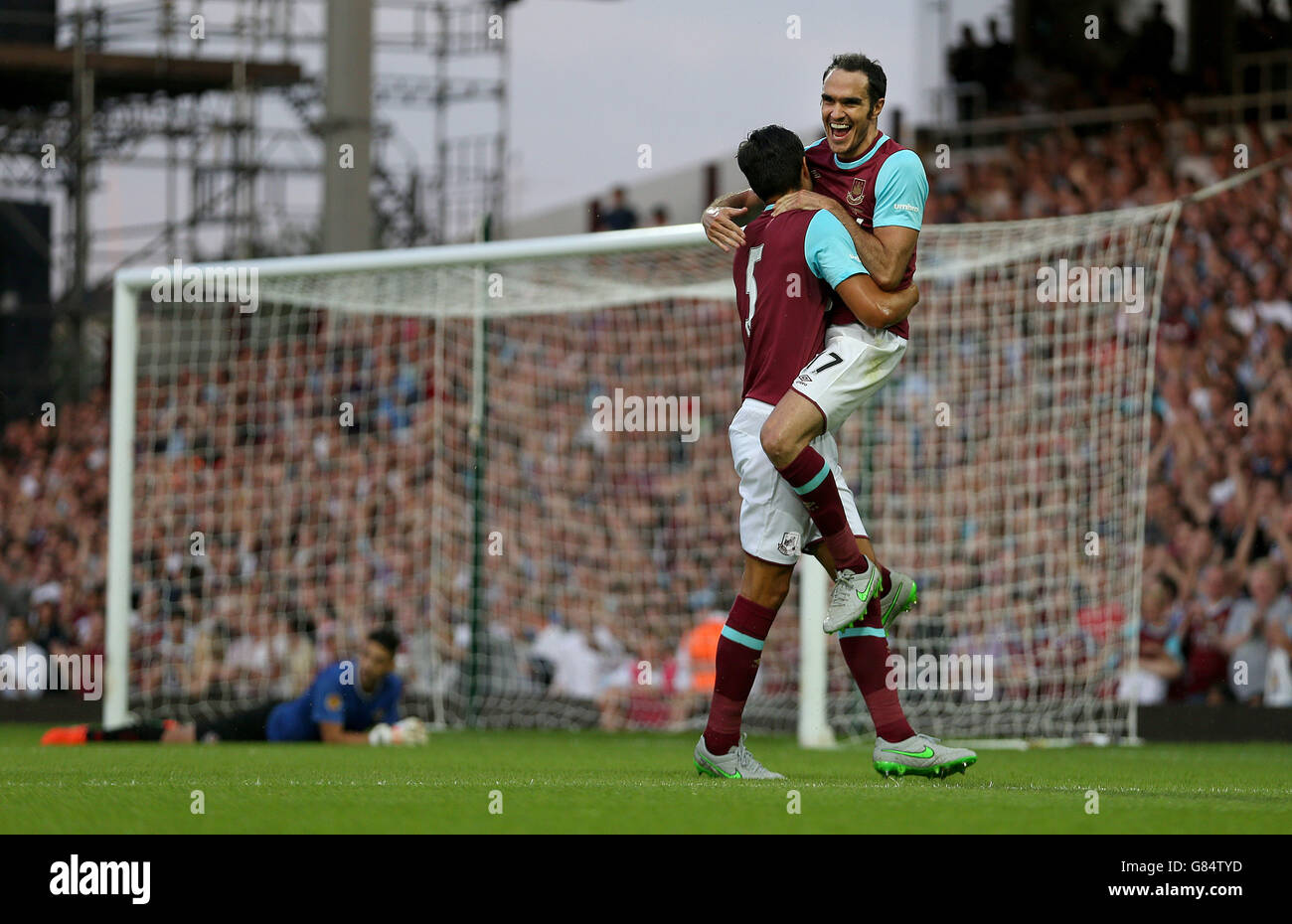 West Ham United's James Tomkins (left) celebrates scoring his sides third goal with teammates Joey O'Brien during the UEFA Europa League first round qualifying match at Upton Park, London. Stock Photo