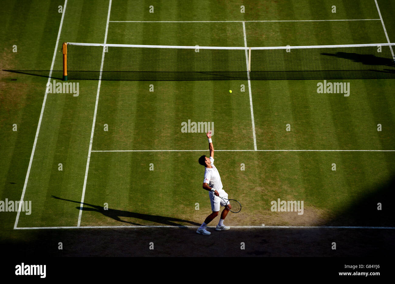 Novak Djokovic in action against Marin Cilic during day Nine of the Wimbledon Championships at the All England Lawn Tennis and Croquet Club, Wimbledon. Stock Photo