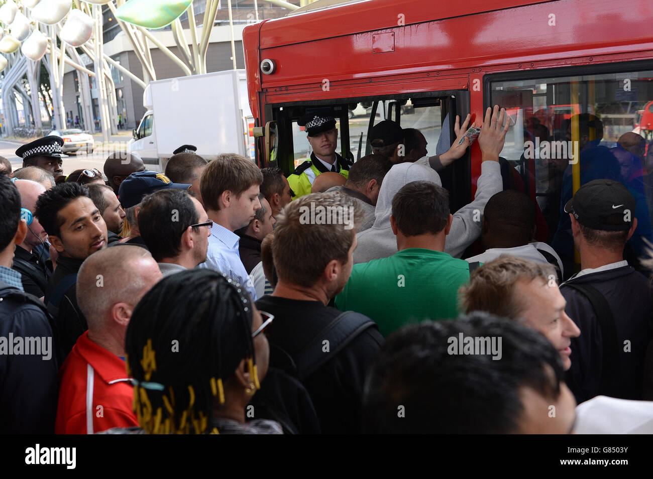 People queue for a bus at Stratford station, London, as commuters face travel misery trying to get to work because of a strike which has brought London Underground to a standstill. Stock Photo
