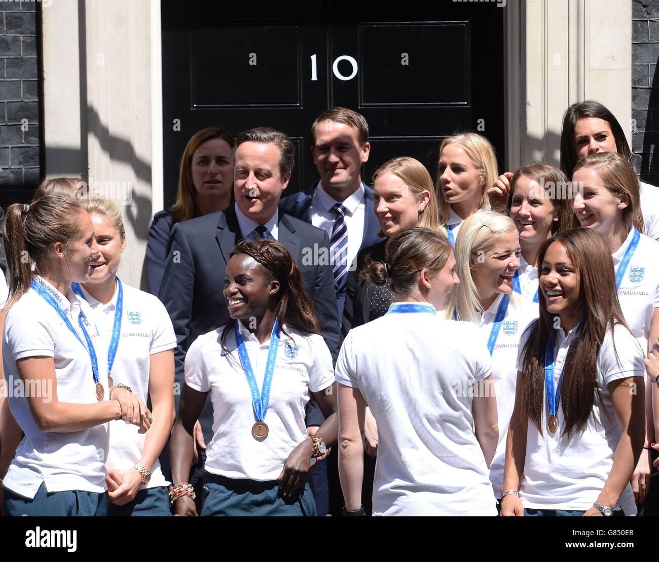 Members of England Women's Football team stand on the steps of 10