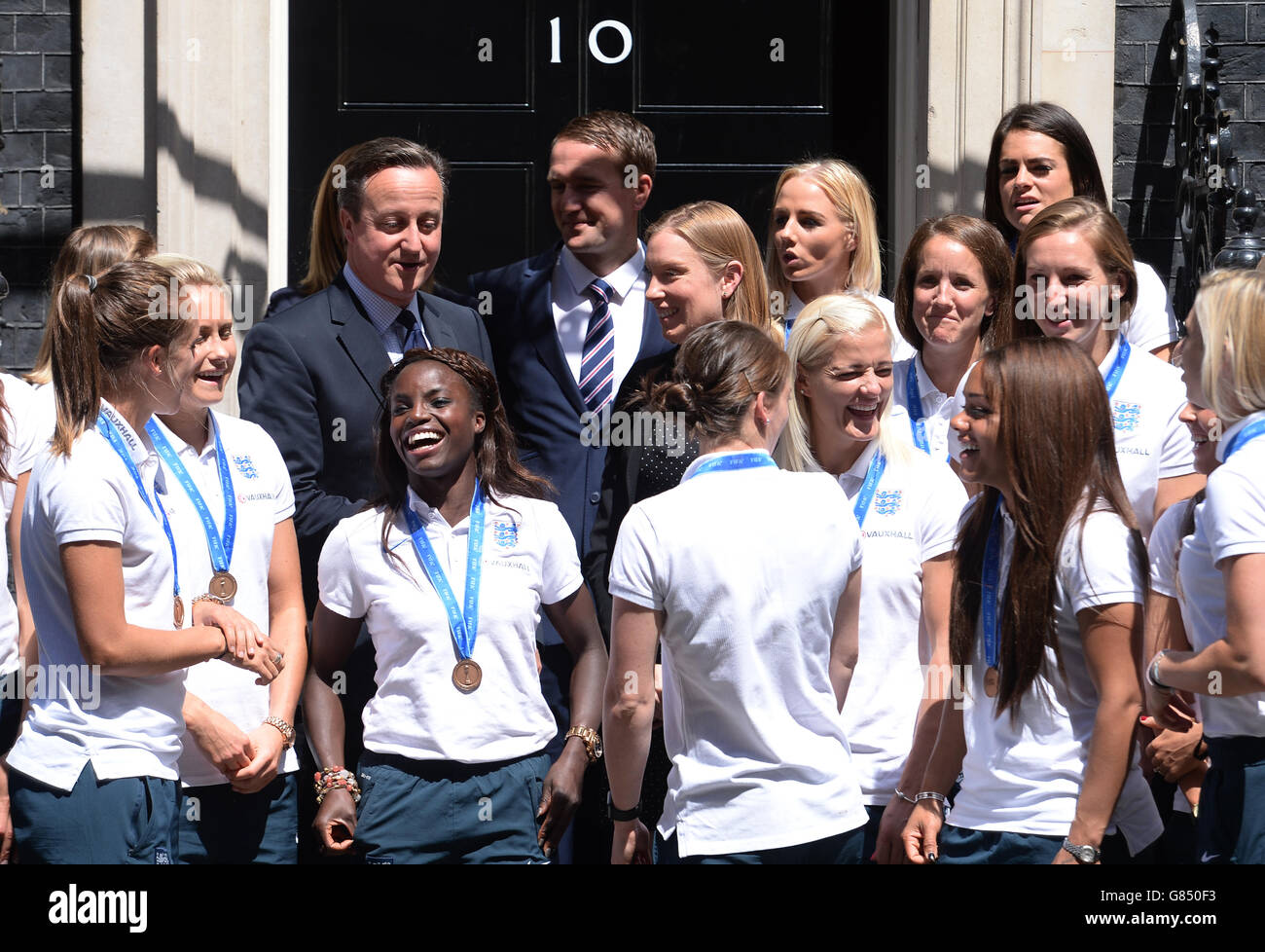 Members of England Women's Football team stand on the steps of 10 Downing Street, London, with Prime Minister David Cameron after a reception. Stock Photo