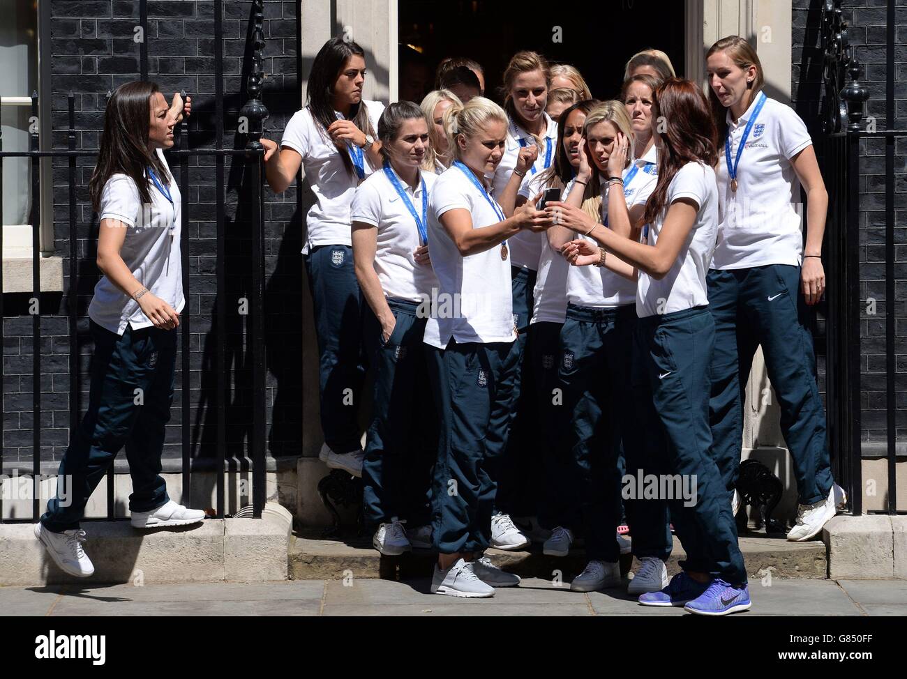 Members of England Women's Football team stand on the steps of 10 Downing Street, London, after a reception with Prime Minister David Cameron. Stock Photo