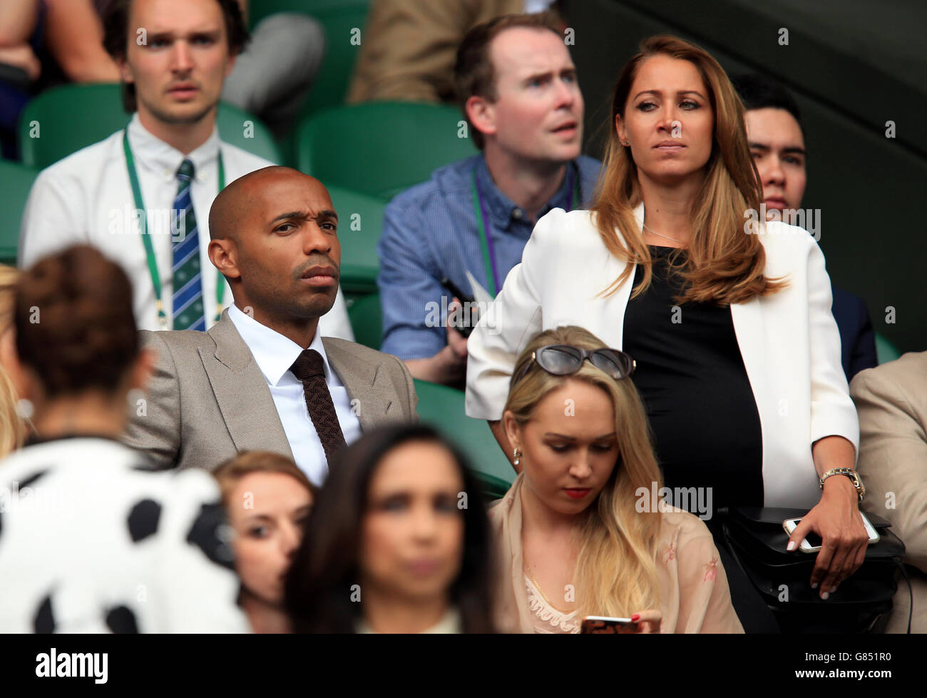 Thierry Henry and Andrea Rajacic watch the Mens Singles Final on day Thirteen of the Wimbledon Championships at the All England Lawn Tennis and Croquet Club, Wimbledon. Stock Photo