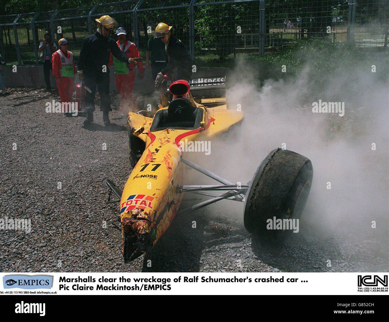 Marshalls clear the wreckage of ralf schumachers crashed car hi-res