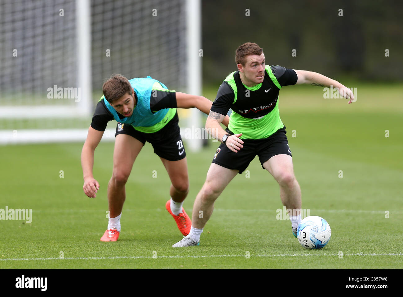 Soccer - Sky Bet League One - Coventry City Training - Ryton Training Ground. Coventry City's John Fleck (right) shields the ball from Jack Finch Stock Photo