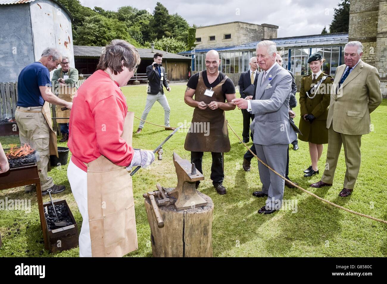 The Prince of Wales with traditional blacksmith trainees during his