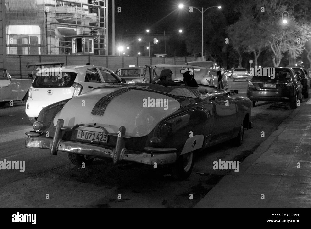 Streets of Old Havana at night with old American cars. Black & white image Stock Photo