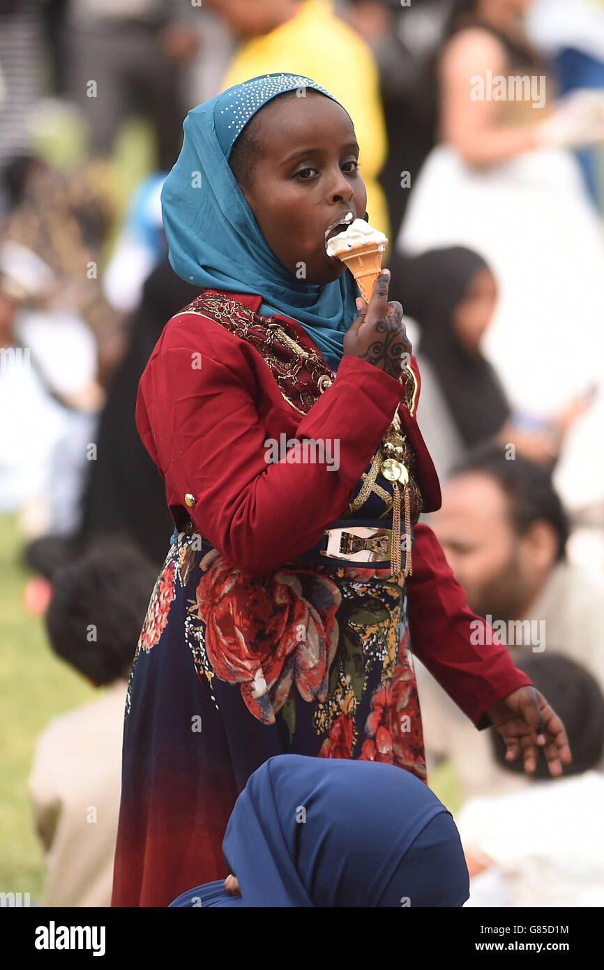 Ismahan Ali, aged nine, enjoys an ice cream during Eid al-Fitr celebrations in Small Heath Park, Birmingham. PRESS ASSOCATION Photo. Picture date: Friday July 17, 2015. Eid al-Fitr marks the end of the holy month of Ramadan where Muslims fast during daylight hours. Photo credit should read: Joe Giddens/PA Wire Stock Photo