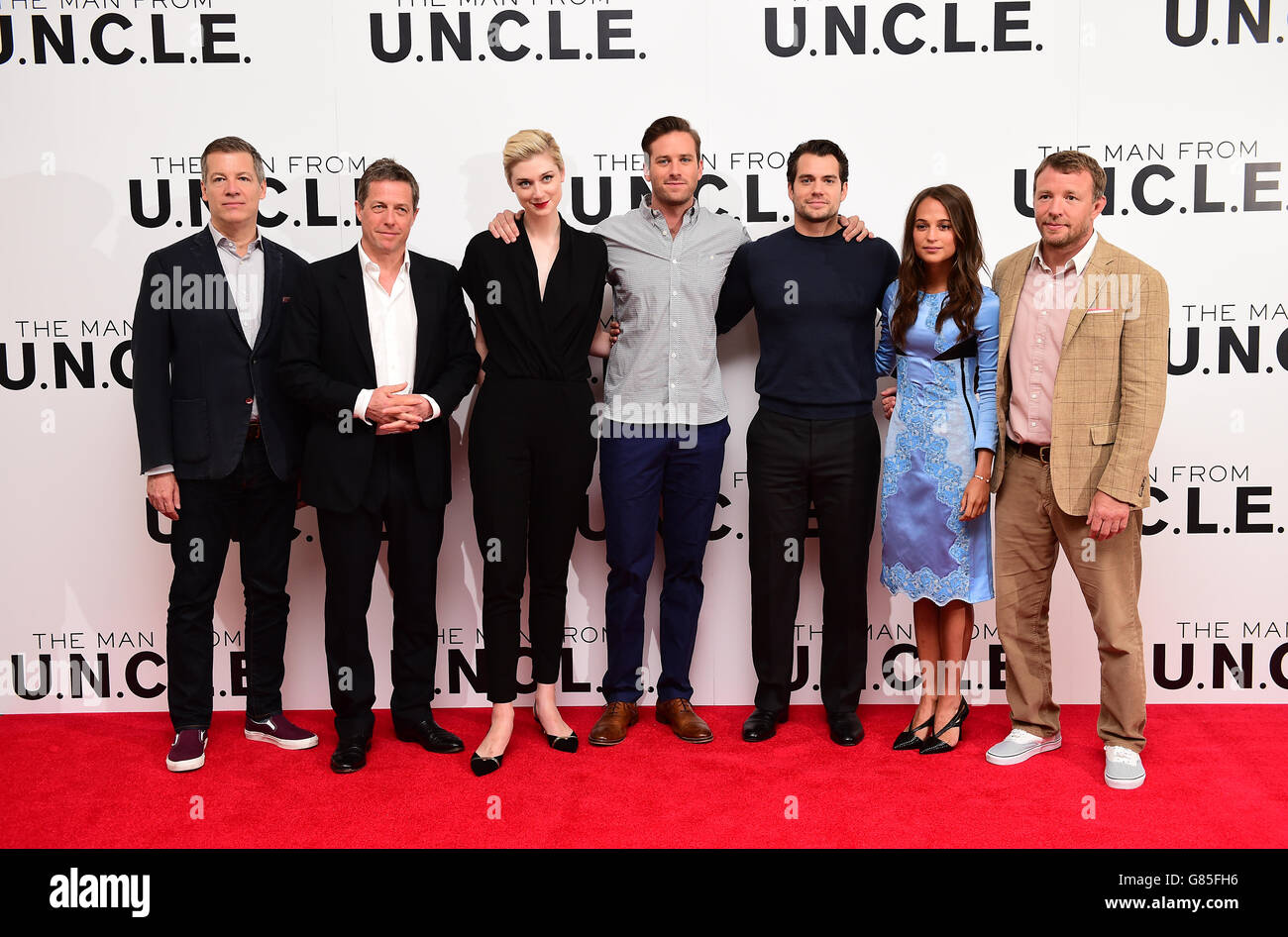 (Left to Right) Lionel Wigram, Hugh Grant, Elizabeth Debicki, Armie Hammer, Henry Cavill, Alicia Vikander and Guy Ritchie attending the Man From U.N.C.L.E photocall held at Roundtables at Claridges, London. PRESS ASSOCIATION Photo. Picture date: Thursday July 23, 2015. Photo credit should read: Ian West/PA Wire Stock Photo
