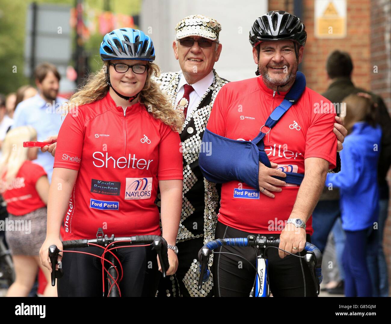 Fourteen-year-old Grace Stewart-Piercy, along with her father Simon, are greeted by John Walters (centre) the Pearly King of Finsbury as they arrive at the London offices of Shelter following their five hundred mile fundraising cycling trip from Edinburgh to London. Stock Photo