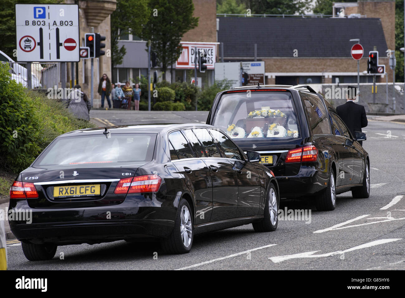 A hearse carrying the coffin of John Yuill following his funeral at St Francis Xavier's RC