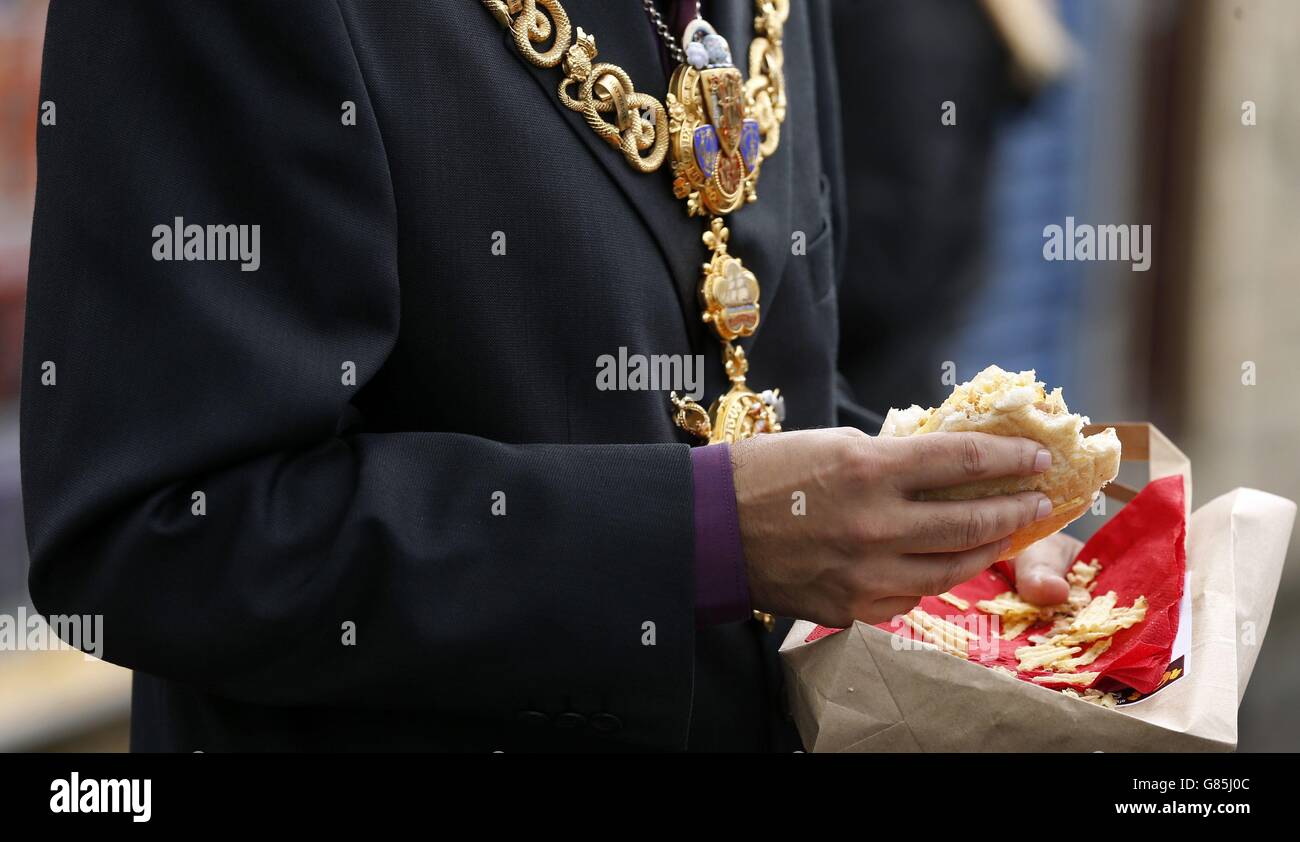 Keighley Mayor Javaid Akhtar enjoys a crisp sandwich outside Mr Crisp, England's first crisp sandwich shop, in Keighley, West Yorkshire. Stock Photo