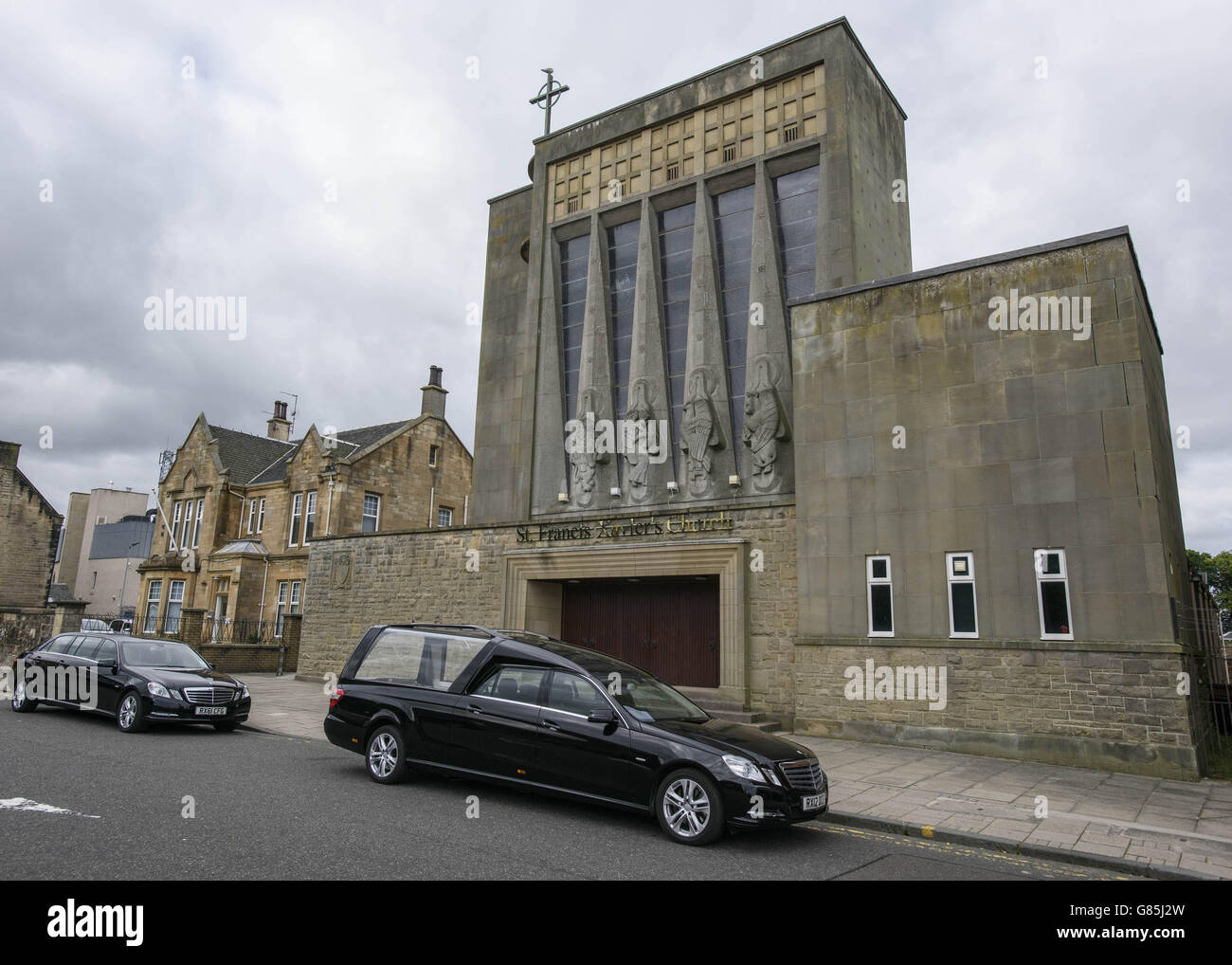 A hearse outside St Francis Xavier's RC Church in Falkirk, Scotland during the funeral of John