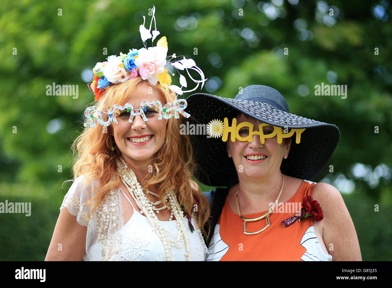 Horse Racing - Glorious Goodwood Festival 2015 - Day Three - Goodwood Racecourse. Female racegoers wearing comedy glasses before the days racing during day three of the Glorious Goodwood Festival, Chichester. Stock Photo