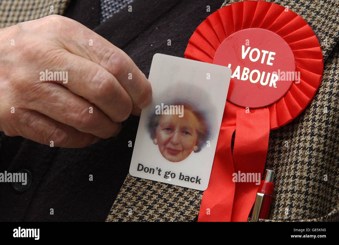 A Labour party supporter holds a hologram card depictig Conservative leader Michael Howard's face morphing into Margeret Thatcher. Stock Photo